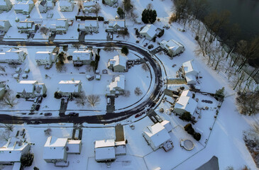 Panorama aerial top view of residential houses areas in snowy covered neighborhood district city of frosty day with by the river with winter landscape
