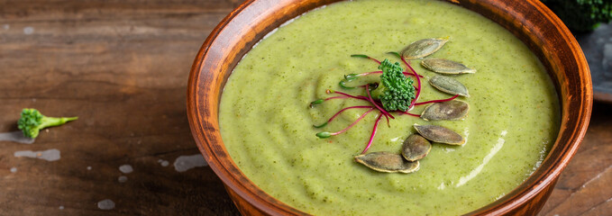 broccoli soup on bowl on wooden background. Vegan soup puree of green vegetables. Vegetarian and diet food