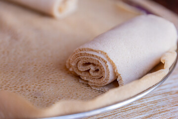 Injera is a sourdough flatbread made from teff flour. It is the national dish of Ethiopia, Eritrea, Somalia and Djibouti