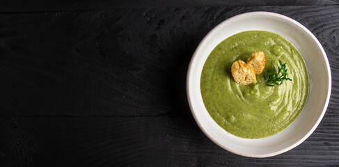 broccoli soup on bowl on wooden background. Vegan soup puree of green vegetables. Vegetarian and diet food