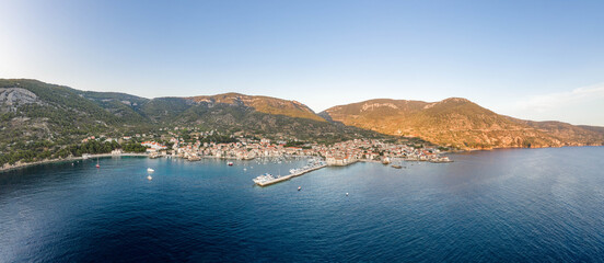 Aerial panoramic view of Komiza village coastline on Vis Island in Croatia sunset hour