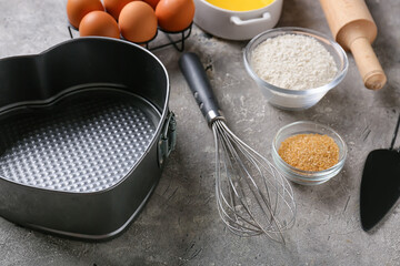Set of kitchen utensils and ingredients for preparing bakery on dark background