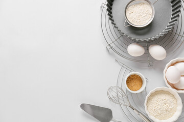 Set of kitchen utensils and ingredients for preparing bakery on light background