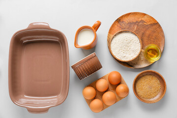 Set of kitchen utensils and ingredients for preparing bakery on light background