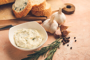 Fresh bread, garlic butter and ingredients on color background