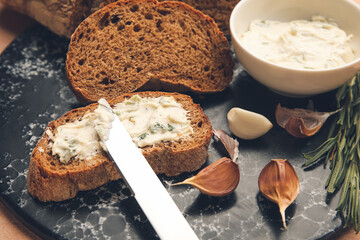 Slices of fresh bread with garlic butter, closeup