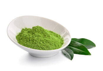 Bowl with powdered matcha tea and fresh leaves on white background