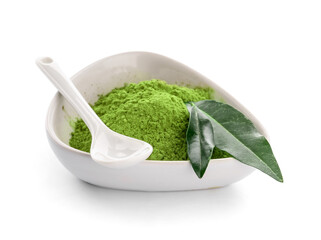 Bowl with powdered matcha tea and spoon on white background