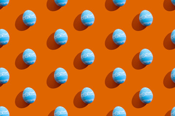 Easter pattern. Holiday seamless banner. Festive art. Paschal symbol. Abstract background. Blue eggs with white ornament design isolated on orange.