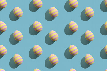 Easter seamless pattern. Festive background. Holiday art. Abstract banner. Yellow eggs with pink paschal ornament isolated on blue pastel textured.