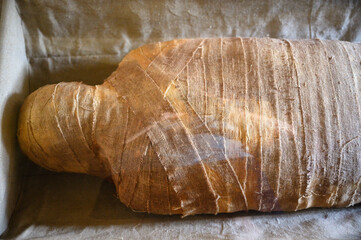 Mummy in a protective plastic case and bandages.