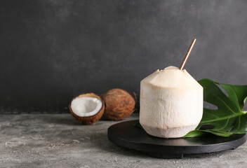 Fresh and ripe coconuts on grey background