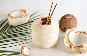 Fresh and ripe coconuts on light background