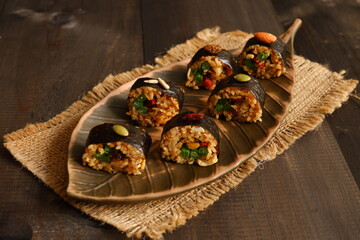 fried rice sushi served in a brown plate on the table