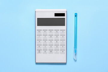 Modern calculator and pen on color background