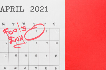Calendar with marked date of April Fool's Day on color background