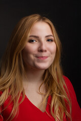 a blonde girl with an overweight plus size, a red overallposing on a dark Studio background