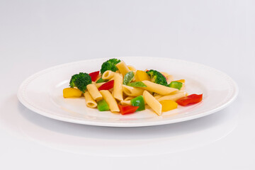Selective focus of a delicious looking pasta salad on a plate on a light background. Healthy food and pasta concept.