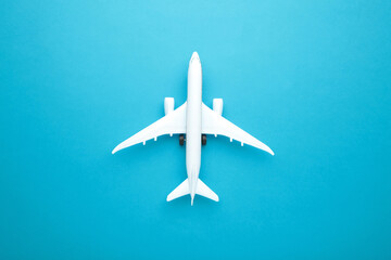 Model airplane on blue pastel color background.