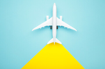 Model airplane on yellow and blue background.