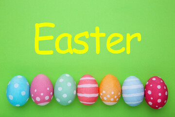 Colorful easter eggs on a green background, pastel