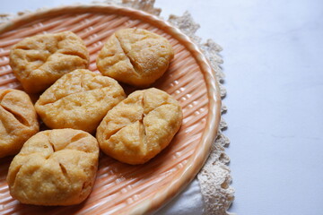 fried tofu in a plate against white background