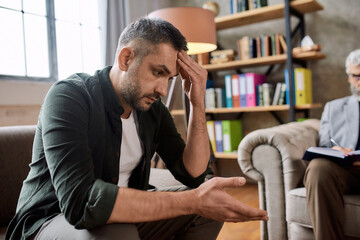 Depressed young caucasian man during appointment with psychotherapist