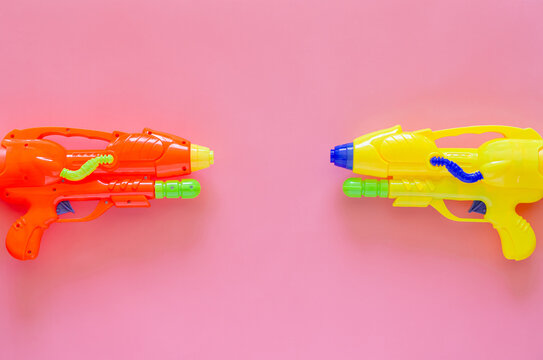 Colorful plastic water gun for Water or Songkran festival on pink background.