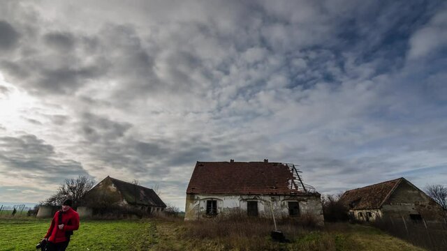 Time lapse of abandoned farm with clouds