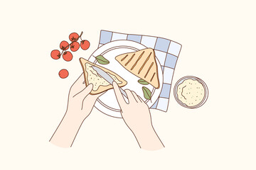 Obraz premium Cooking, food preparation, breakfast concept. Human hands making sandwich with cherry tomato cream cheese and herbs for lunch or breakfast over table vector illustration, top view 