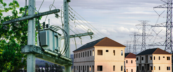 Distribution high voltage transformer for power transmission to industry with sunset sky...