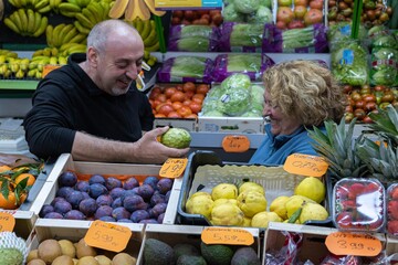 Two fruit sellers talking at the fruit store