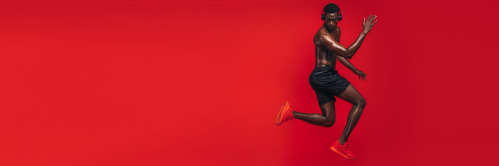 African man working out in red background