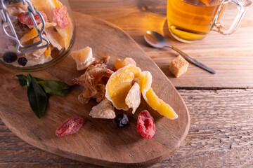 Assortment of sweet dried fruit. Assortment of sweet colorful dried fruit on a dark colored table.