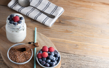 Portion of flax seeds in a small bowl. Healthy super foods flax seeds in a bowl mixed with yoghurt ready to eat. These seed are very healthy and can be eaten with a variety of different dishes.