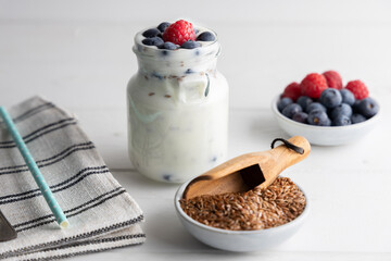 Portion of flax seeds in a small bowl. Healthy super foods flax seeds in a bowl mixed with yoghurt ready to eat. These seed are very healthy and can be eaten with a variety of different dishes.