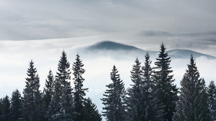 Snow-capped mountain peak against the backdrop of clouds.