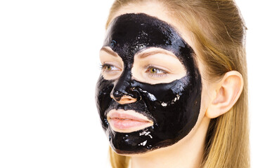 Woman with black peel off mask on face