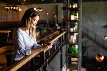 Beautiful woman using mobile phone. Business, technology, social network concept