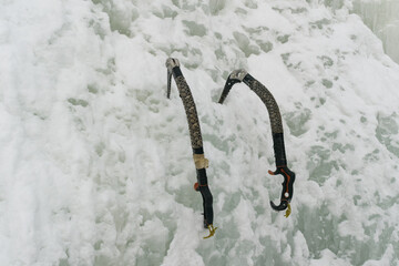 Ice axes are stuck in ice - an instrument designed for difficult ice corridors and dry-tooling.