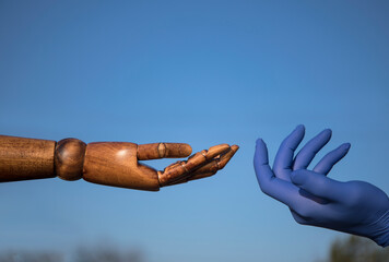 Hands concept. Love photo. Wooden hand. Gloves. Sky background