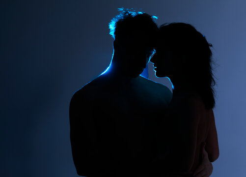 silhouette of a couple. Sexy couple love. Sexy photo. Dark background. Sensual. Man and woman. 