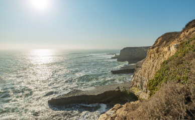 Beautiful seascape of the Pacific coast in California, waves, rocks, sky, sun. Concept, perfect postcard and guide.