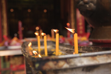 Calm in the temple with the focus of the first candle