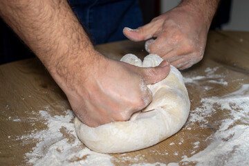 person kneading dough