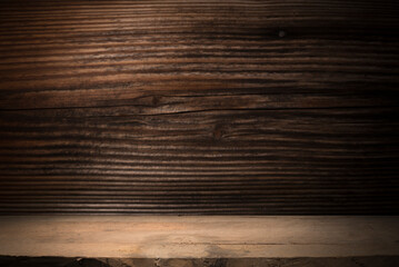 Naklejka premium Selected focus empty brown wooden table and wall texture or old black brick wall blur background image. for your photomontage or product display