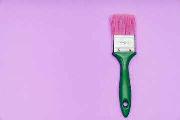 paint brush on a pink background. tools for painting and repair work.