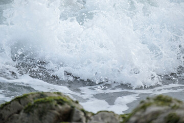 波打ち際の岩に打ちつける波しぶき