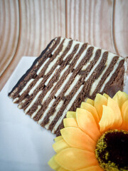 A slice of chocolate spartak cake or chocolate honey cake. Selective focus points. Blurred background