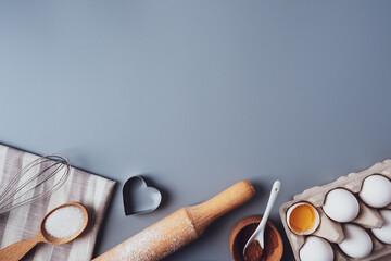 Flat Lay composition, ingredients for baking cookies on a gray background, copy space. Making cookies or cupcakes for Valentine's Day, Mother's Day, Father's Day. The concept of festive food